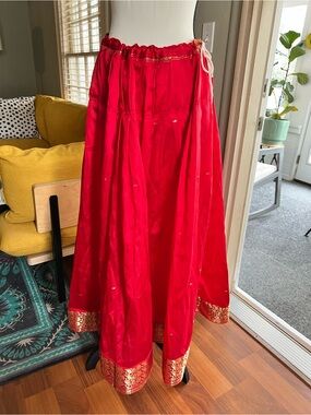 Handmade red silky Lehenga skirt, with gold stitched designs, drawstring waist.